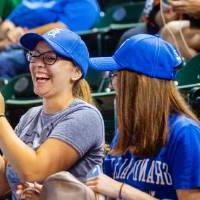 Two women cheering in the stands of Comerica Park with GVSU clothes on